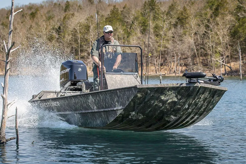 The Image of Manufacturer Provided Image: 2026 Crestliner 1760 Retriever FCC boat navigating a lake with a person steering. - 1