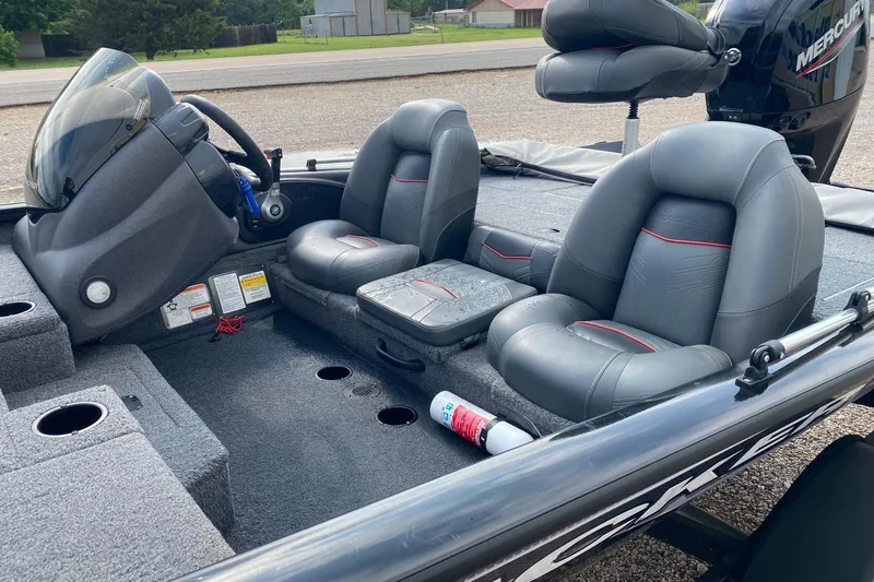 Slide: The Image of 2022 Tracker Pro Team 175 TXW boat interior with gray seats and steering console. - 10