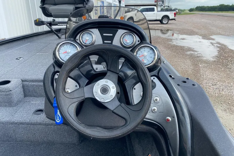 Slide: The Image of 2022 Tracker Pro Team 175 TXW boat dashboard with steering wheel and gauges. - 7