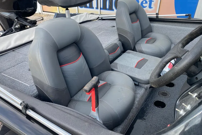 Slide: The Image of 2022 Tracker Pro Team 175 TXW boat interior with gray seats and steering wheel. - 8