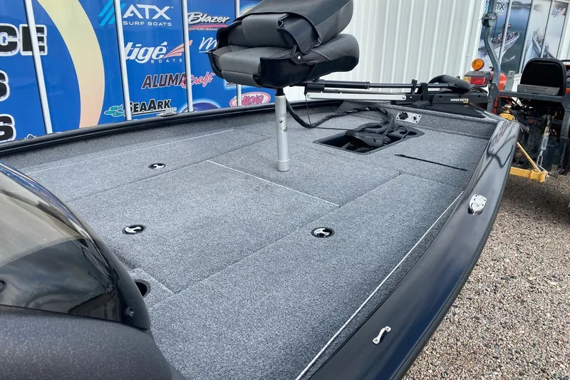 Slide: The Image of 2022 Tracker Pro Team 175 TXW boat with carpeted deck and seating. - 9