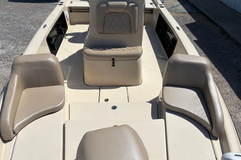 Slide: The Image of 2018 Blue Wave 2200 PureBay boat interior with beige seating and storage compartments. - 10