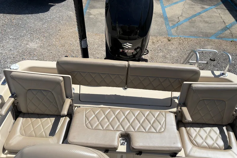 Slide: The Image of 2018 Blue Wave 2200 PureBay boat interior with beige seating and Suzuki 175 engine. - 11