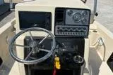 Slide: The Image of 2018 Blue Wave 2200 PureBay boat dashboard with steering wheel and control panel. - 13