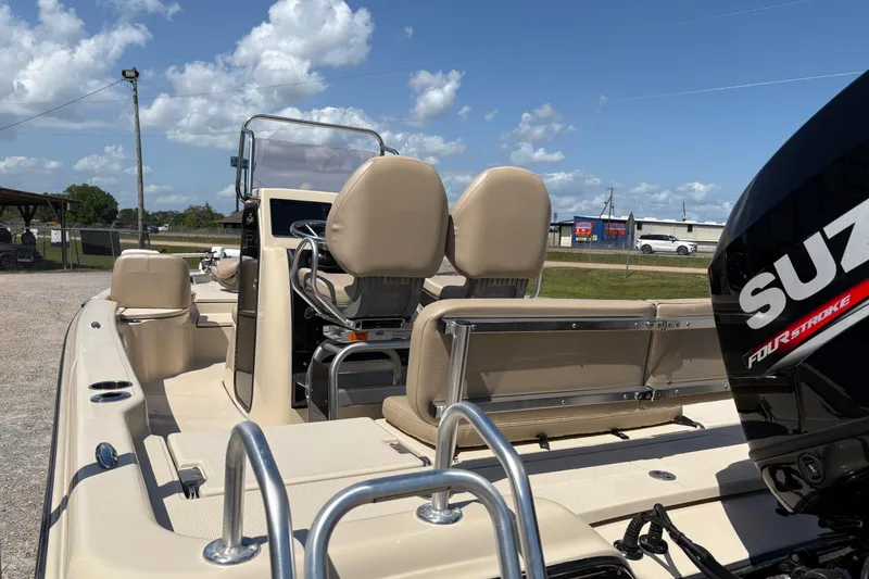 Slide: The Image of 2018 Blue Wave 2200 PureBay boat with Suzuki four-stroke engine, beige seating, and clear skies. - 15