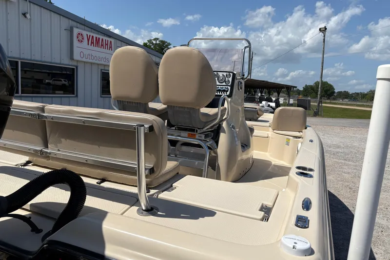 Slide: The Image of 2018 Blue Wave 2200 PureBay boat at Yamaha Outboards dealership, featuring beige seating and console. - 16
