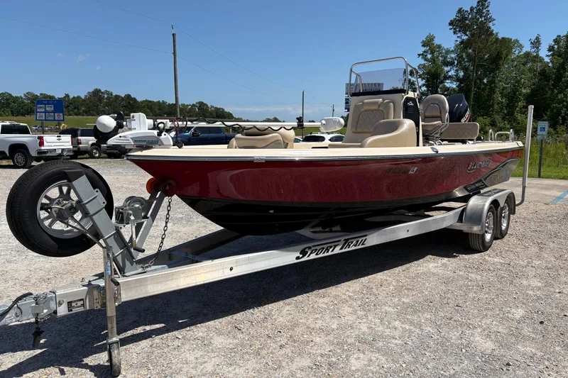Slide: The Image of 2018 Blue Wave 2200 PureBay boat on trailer, parked outdoors under clear sky. - 3