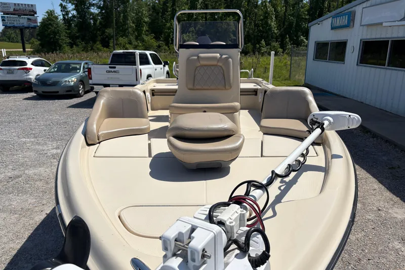 Slide: The Image of 2018 Blue Wave 2200 PureBay boat with seating and trolling motor in a parking lot. - 6
