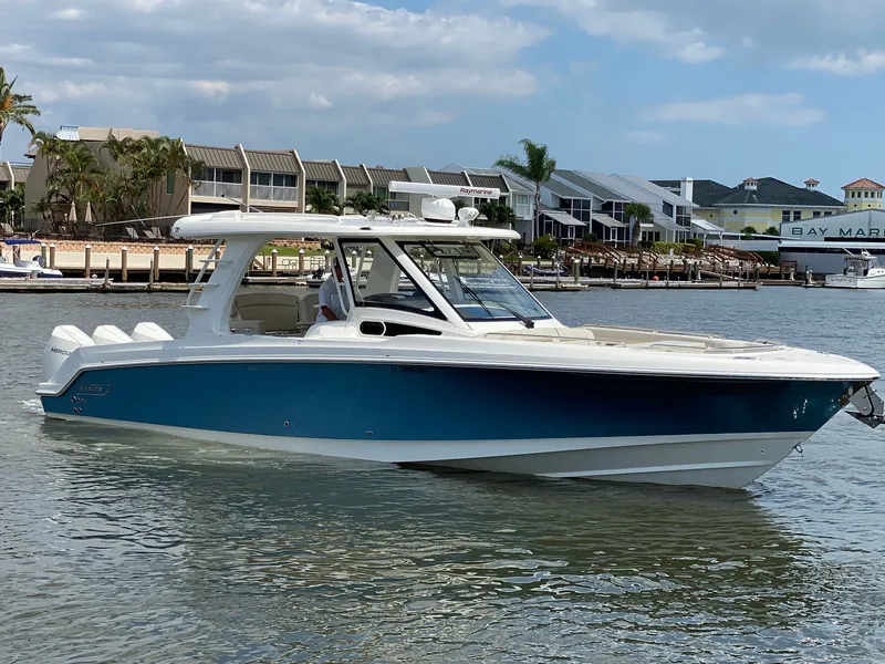Slide: The Image of 2020 Boston Whaler 350 Realm on calm water near dock. - 14