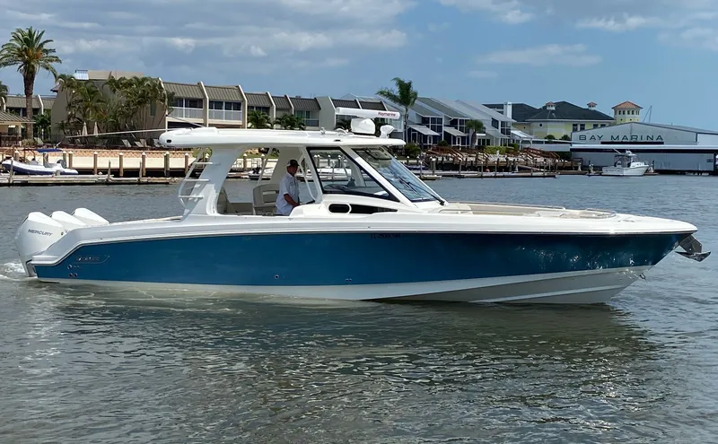 Slide: The Image of 2020 Boston Whaler 350 Realm boat on calm water near dock. - 15
