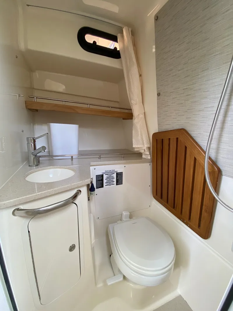 Slide: The Image of Interior of 2020 Boston Whaler 350 Realm with toilet and sink. - 20