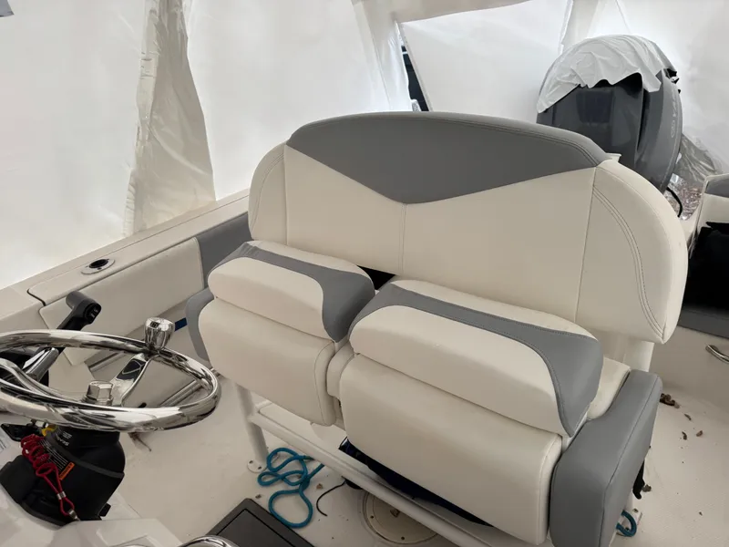 Slide: The Image of Interior of a 2022 Robalo R200 CC boat with gray and white seating. - 11