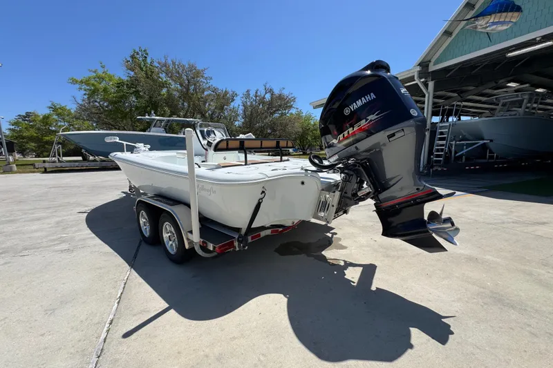 Slide: The Image of 2016 Yellowfin 21 Hybrid boat with Yamaha outboard motor on a trailer. - 16