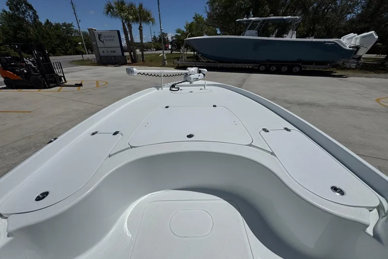 Slide: The Image of 2016 Yellowfin 21 Hybrid boat deck with storage compartments and trolling motor. - 19