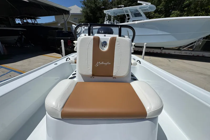 Slide: The Image of 2016 Yellowfin 21 Hybrid boat interior with tan and white seating. - 25