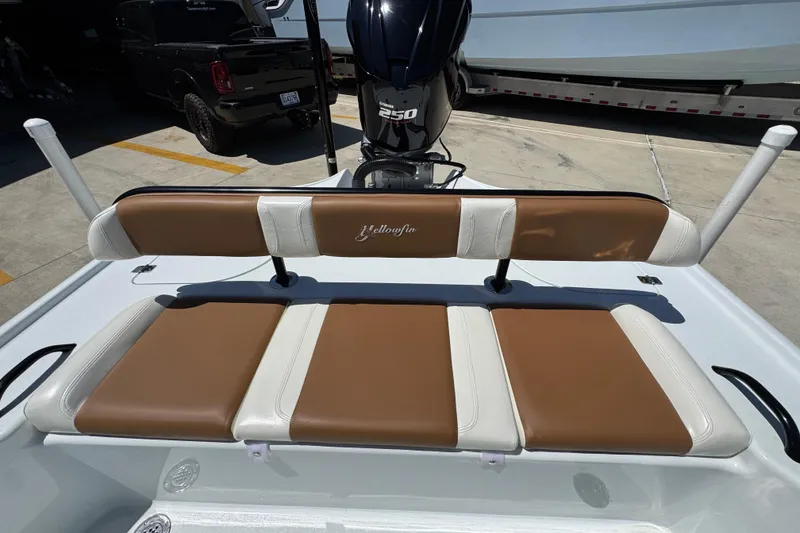 Slide: The Image of 2016 Yellowfin 21 Hybrid boat with brown and white seating, featuring a 250 horsepower engine. - 29