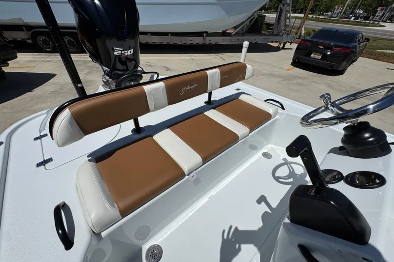 Slide: The Image of 2016 Yellowfin 21 Hybrid boat interior with brown and white seating, Yamaha 250 engine. - 30