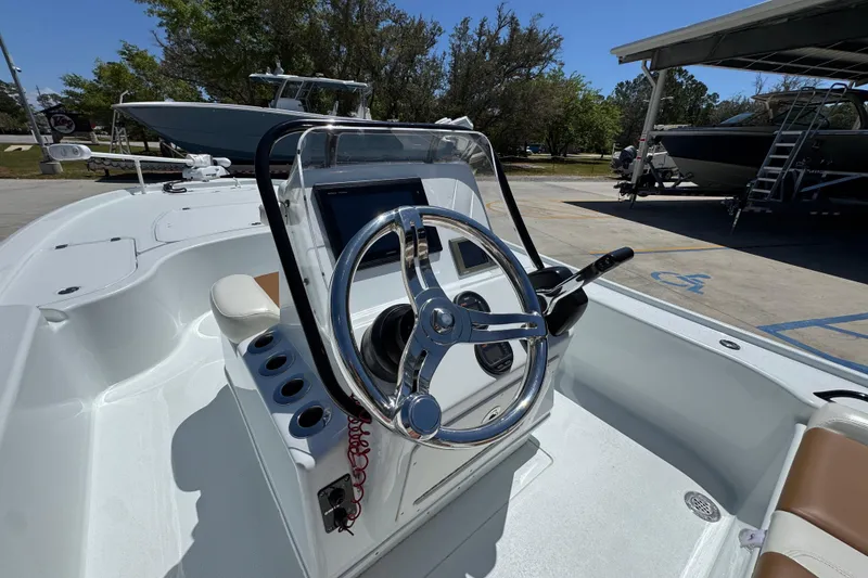 Slide: The Image of 2016 Yellowfin 21 Hybrid boat steering console with chrome wheel and control panel. - 31