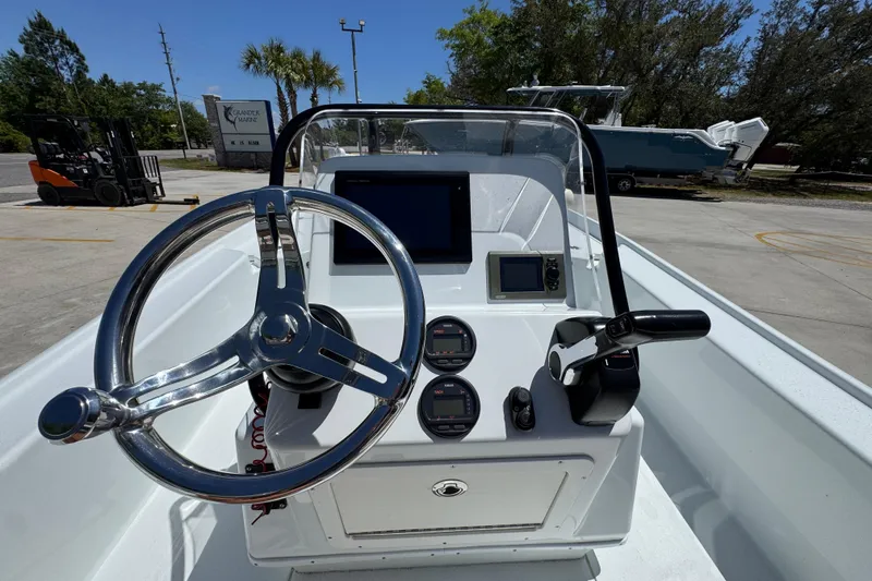 Slide: The Image of 2016 Yellowfin 21 Hybrid boat dashboard with steering wheel and navigation controls. - 32