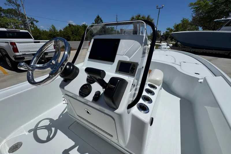 Slide: The Image of 2016 Yellowfin 21 Hybrid boat console with steering wheel and navigation equipment. - 33