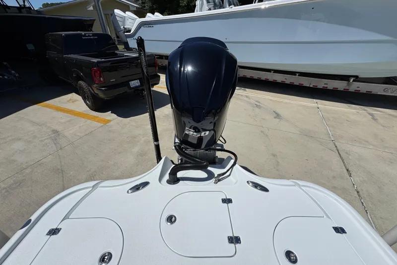 Slide: The Image of 2016 Yellowfin 21 Hybrid boat with powerful outboard motor in a parking area. - 34
