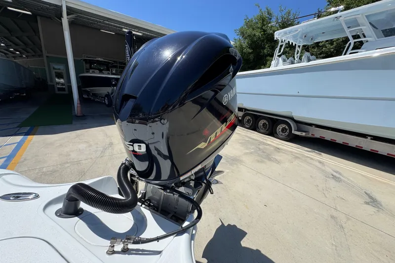 Slide: The Image of 2016 Yellowfin 21 Hybrid boat with Yamaha 150 outboard motor in a marina setting. - 35