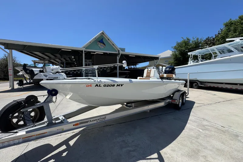 Slide: The Image of 2016 Yellowfin 21 Hybrid boat on trailer at marina under clear blue sky. - 4