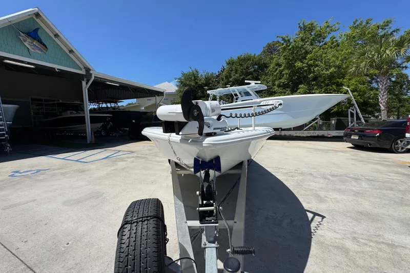 Slide: The Image of 2016 Yellowfin 21 Hybrid boat on trailer at marina, sunny day. - 6