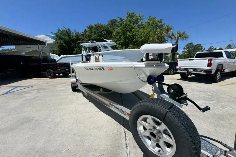 Slide: The Image of 2016 Yellowfin 21 Hybrid boat on trailer in sunny parking lot. - 7