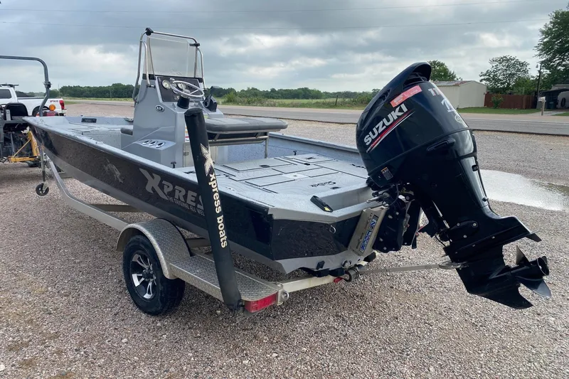 Slide: The Image of 2018 Xpress H20B Bay boat with Suzuki outboard motor on trailer. - 3