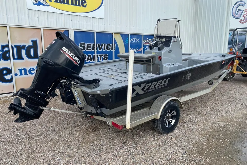 Slide: The Image of 2018 Xpress H20B Bay boat with Suzuki outboard motor on a trailer. - 5