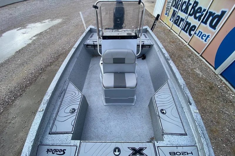 Slide: The Image of 2018 Xpress H20B Bay boat interior with seating and storage compartments. - 8
