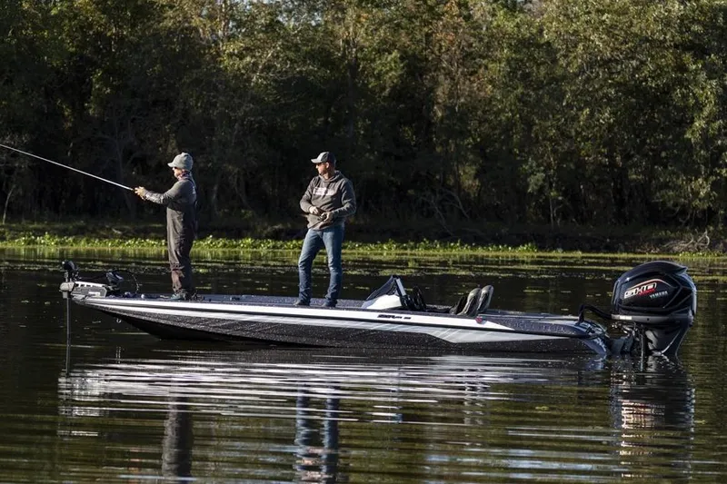 Slide: The Image of Manufacturer Provided Image: Two people fishing on a 2026 Skeeter ZXR21 SE boat in a serene lake. - 12
