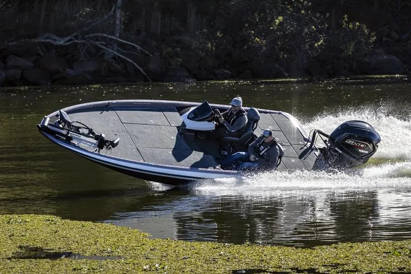 Slide: The Image of Manufacturer Provided Image: 2026 Skeeter ZXR21 SE boat speeding on a lake with two passengers. - 13