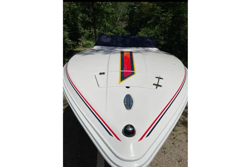 Slide: The Image of 2001 Donzi 28 ZX boat with colorful stripes, viewed from the front. - 4