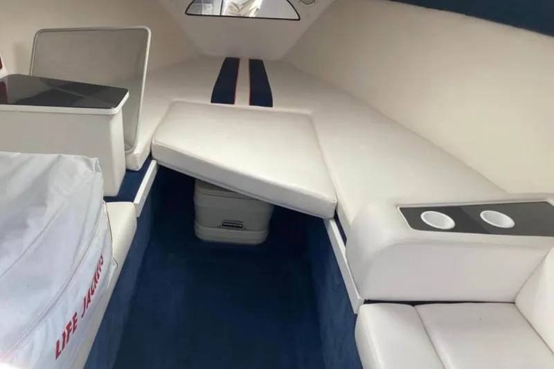 Slide: The Image of Interior of a 2001 Donzi 28 ZX boat with white seating and blue carpet. - 6