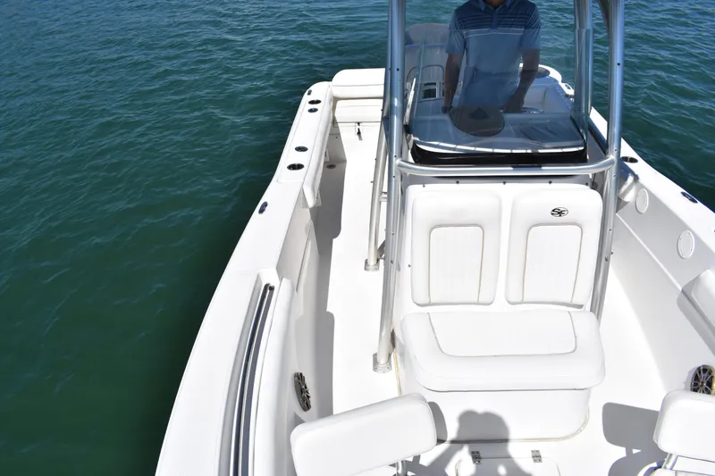 Slide: The Image of 2014 Sea Fox 226 Commander boat on water, featuring center console and seating. - 15