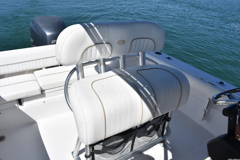 Slide: The Image of 2014 Sea Fox 226 Commander boat interior with white seating and ocean backdrop. - 17