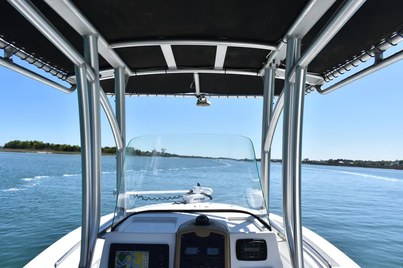 Slide: The Image of 2014 Sea Fox 226 Commander boat navigating calm waters under clear blue skies. - 18