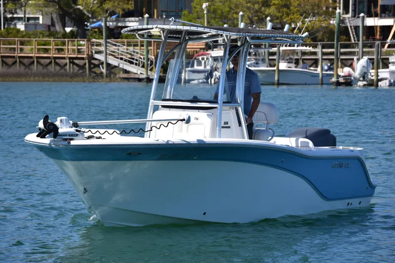 Slide: The Image of 2014 Sea Fox 226 Commander boat cruising on a sunny day near a marina. - 4