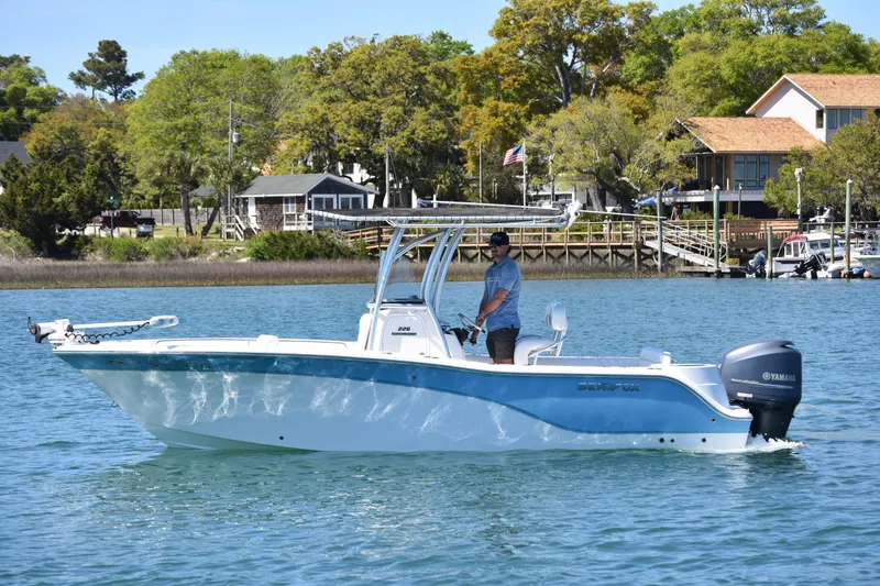 Slide: The Image of 2014 Sea Fox 226 Commander boat cruising on a scenic lake with lush greenery. - 5