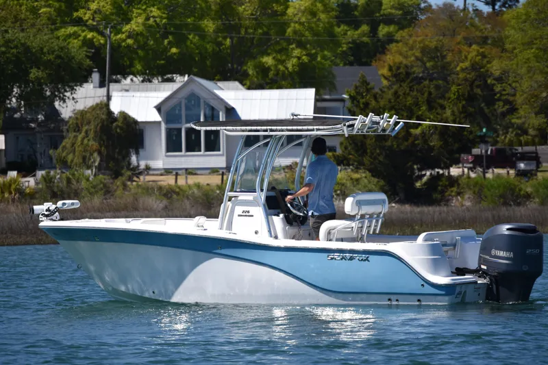 Slide: The Image of 2014 Sea Fox 226 Commander boat cruising on a calm waterway near a house. - 6