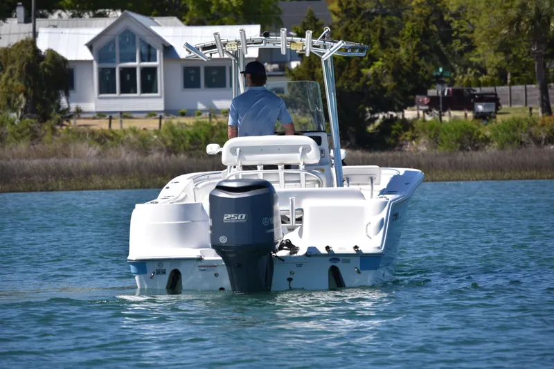 Slide: The Image of 2014 Sea Fox 226 Commander boat cruising on a calm lake near a house. - 7