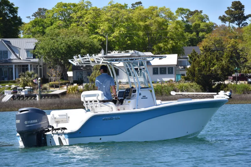 Slide: The Image of 2014 Sea Fox 226 Commander boat cruising on a sunny day near waterfront homes. - 8