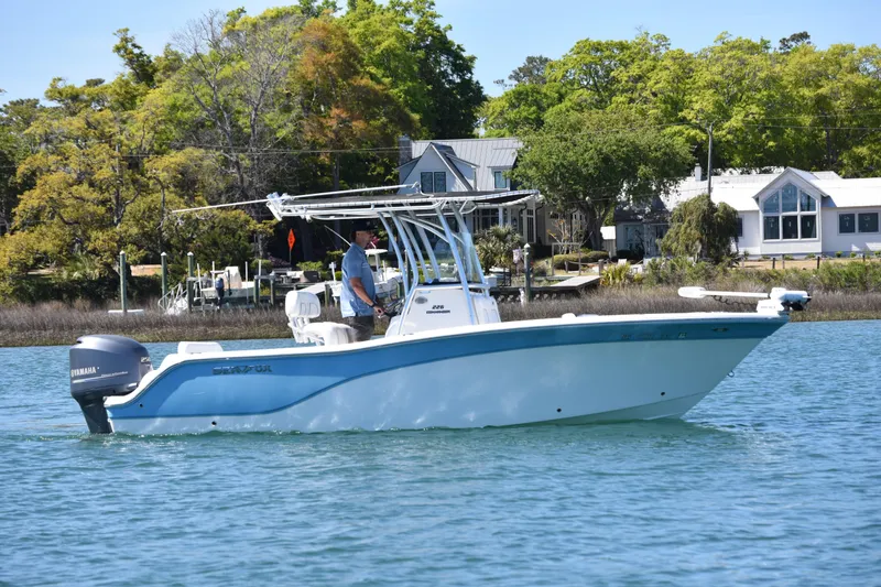 Slide: The Image of 2014 Sea Fox 226 Commander boat cruising on a sunny day near waterfront homes. - 9