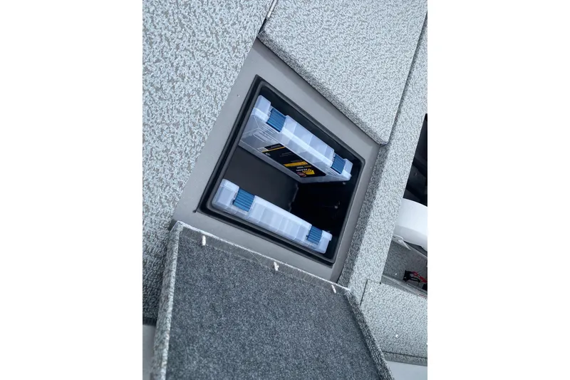 Slide: The Image of Storage compartment in 2026 G3 Sportsman 1610 boat with organized tackle boxes. - 10