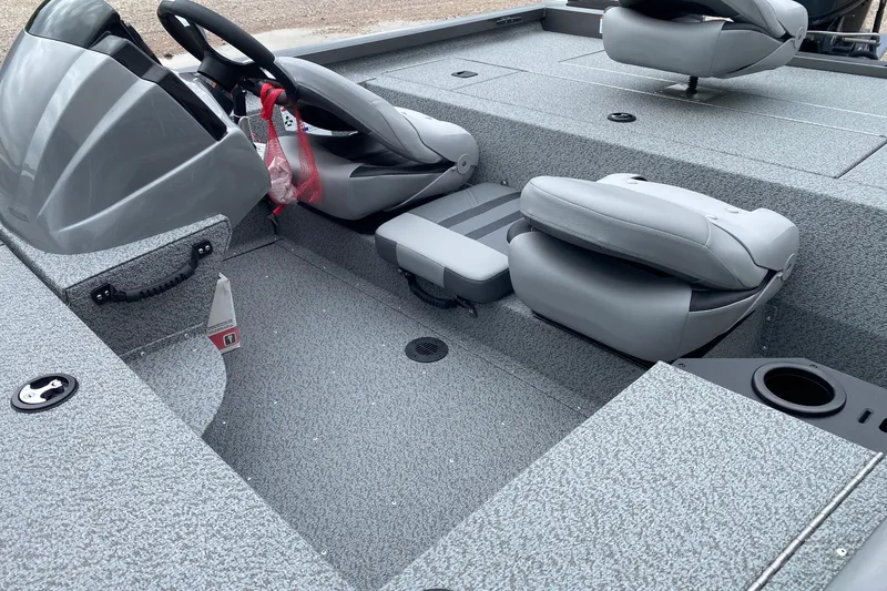 Slide: The Image of 2026 G3 Sportsman 1610 boat interior with gray seating and steering console. - 12