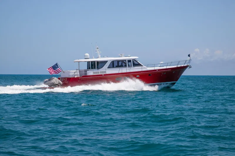 Slide: The Image of 2027 Hunt Yachts Ocean 63 Express cruising on open sea with American flag. - 1