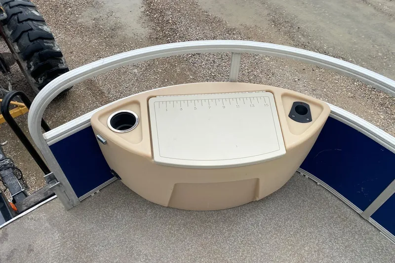 Slide: The Image of 2016 Sun Tracker Fishin' Barge 22 DLX deck with fishing station and cup holders. - 9