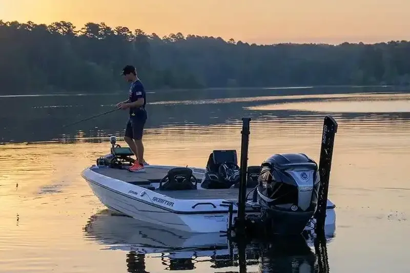 Slide: The Image of Manufacturer Provided Image: Man fishing on a 2026 Skeeter FXR20 FLEX boat at sunrise on a calm lake. - 14